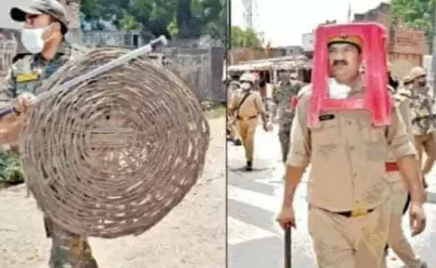 உ.பி.யில் அடுத்த சர்ச்சை.. பிளாஸ்டிக் சேர், கூடையை கவசமாக அணிந்த போலீசார் !!